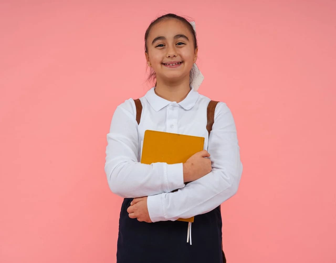 A child smiling at a desk